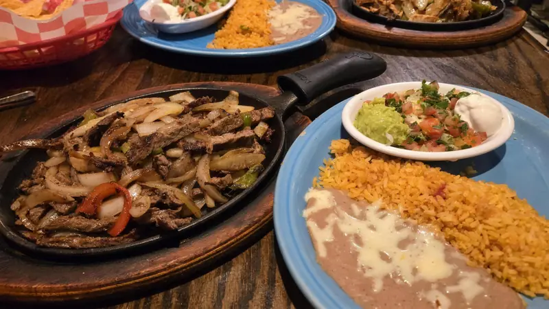 Beef fajitas with rice, refried beans, guacamole and pico de gallo at El Rancho